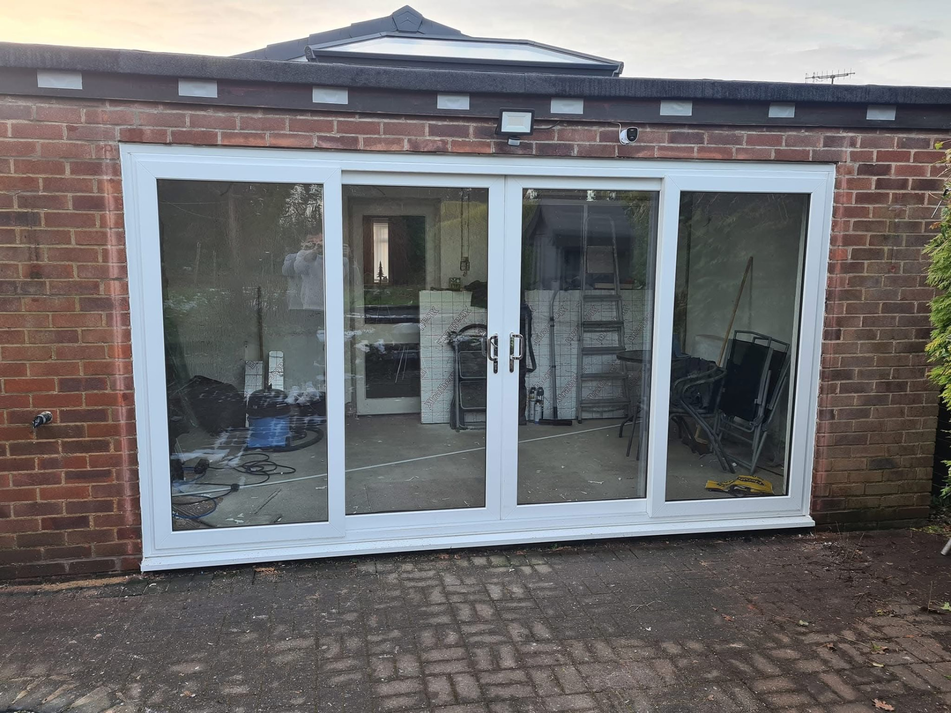 New white uPVC sliding patio doors replacing worn aluminium doors in Staffordshire