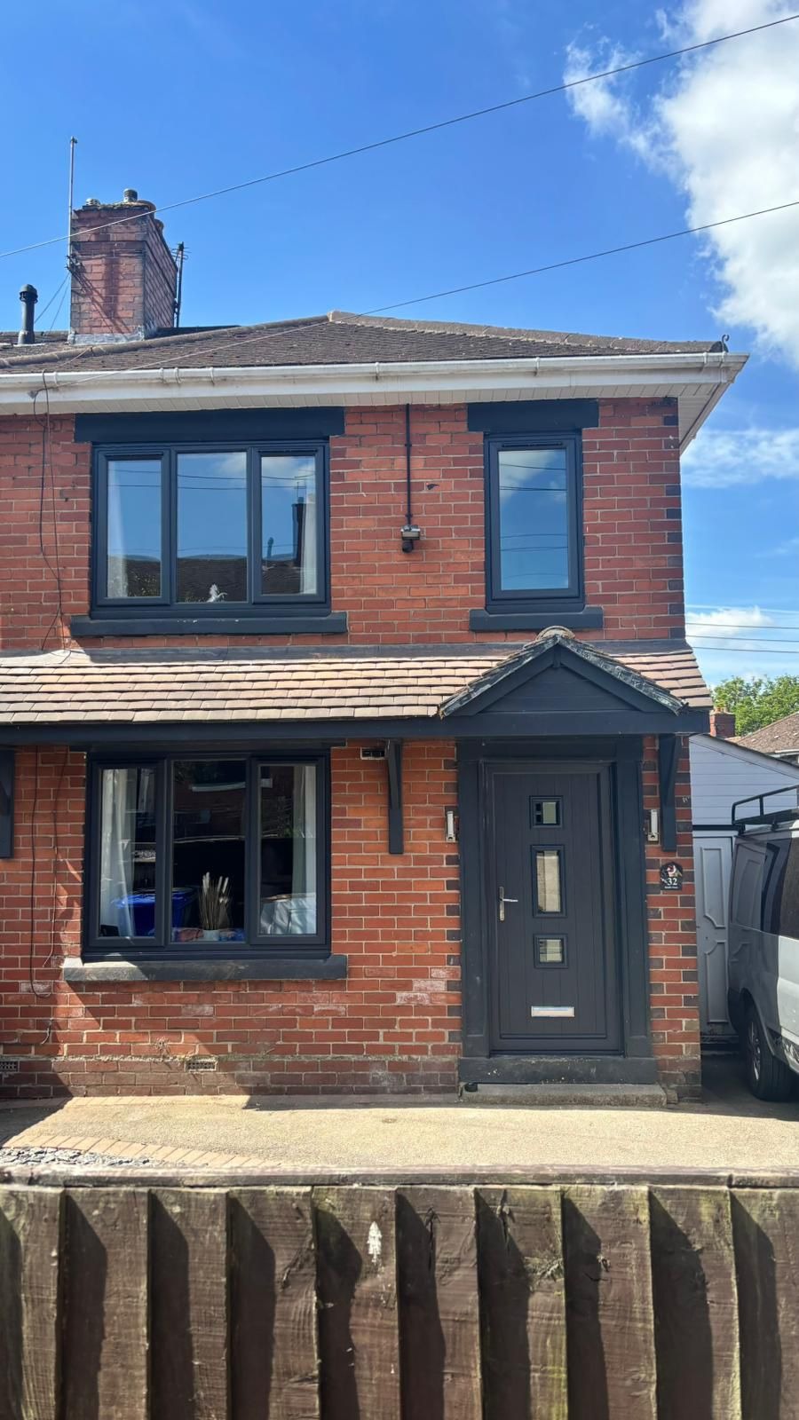 Red brick semi-detached home with anthracite grey uPVC windows and composite door