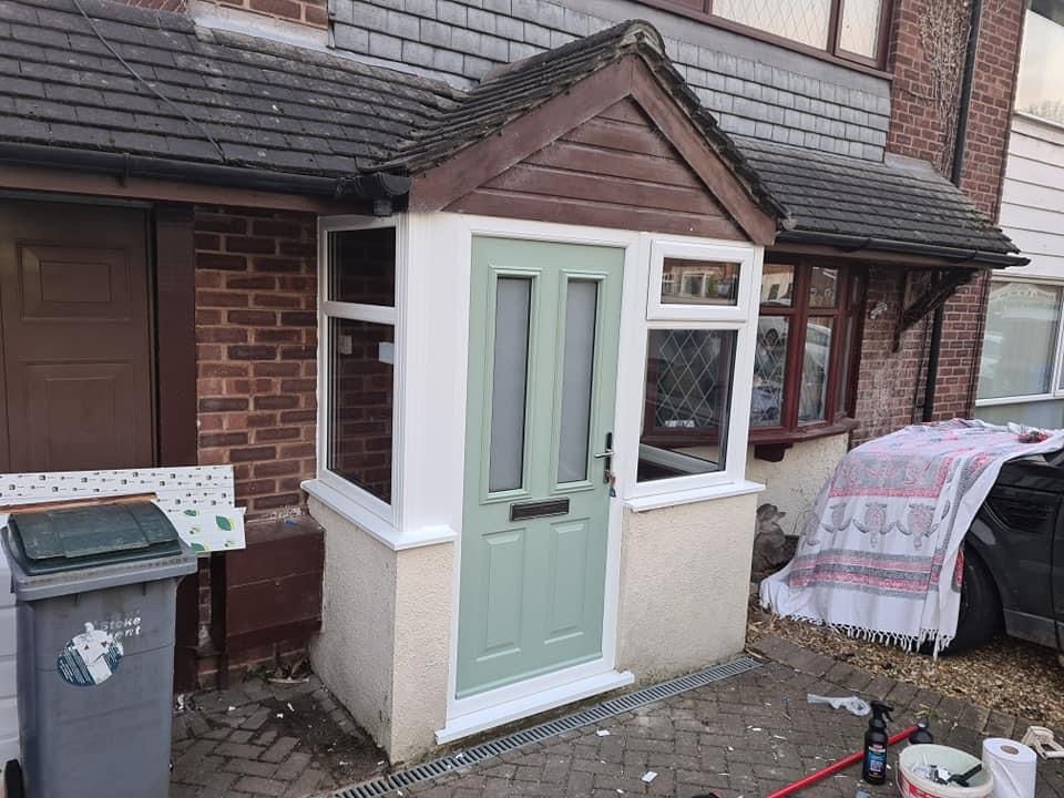 Sage green composite door installed in a white uPVC porch infill in Staffordshire
