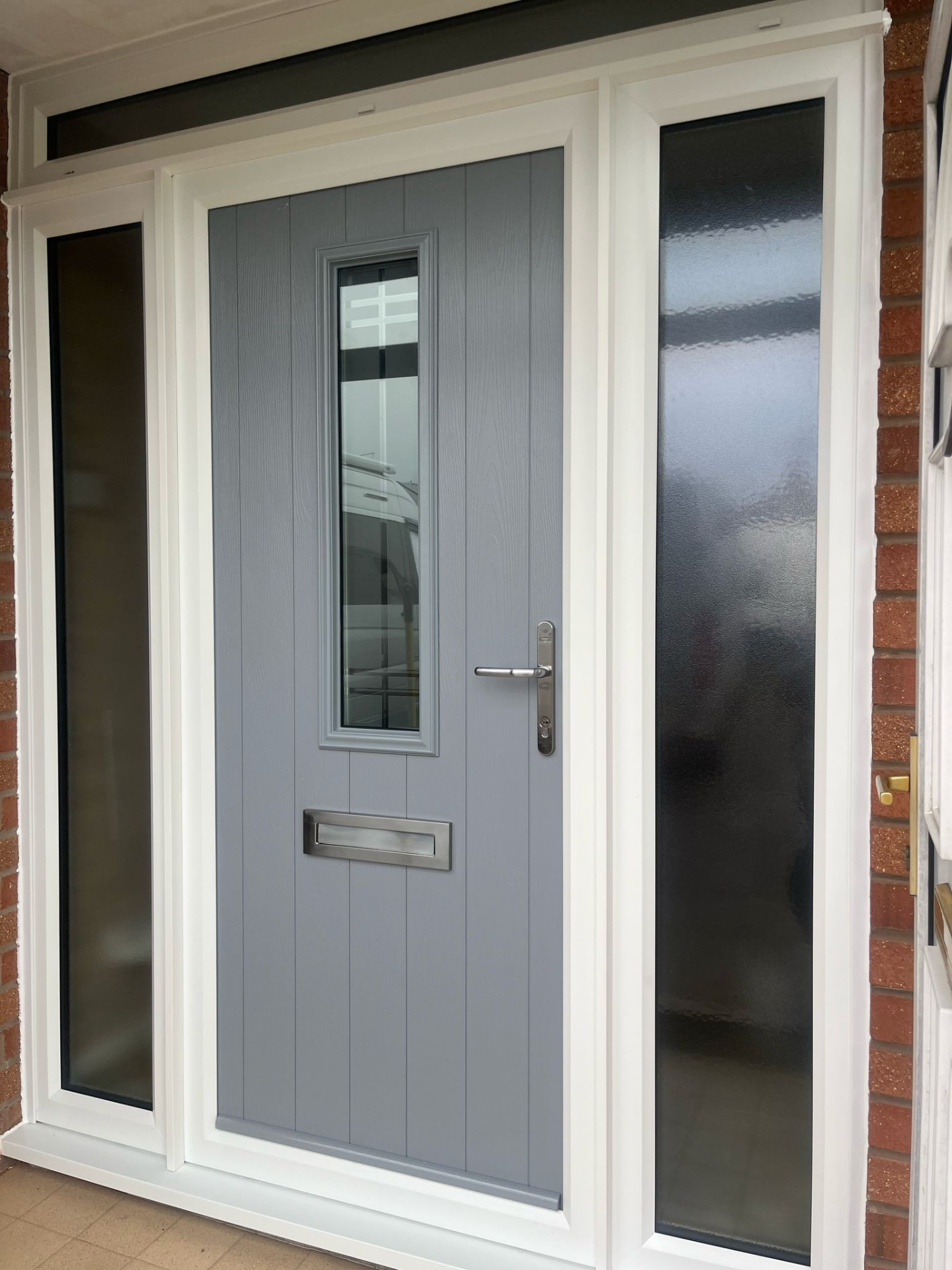 Mid-grey composite door with full-height frosted side panels installed in Stoke-on-Trent
