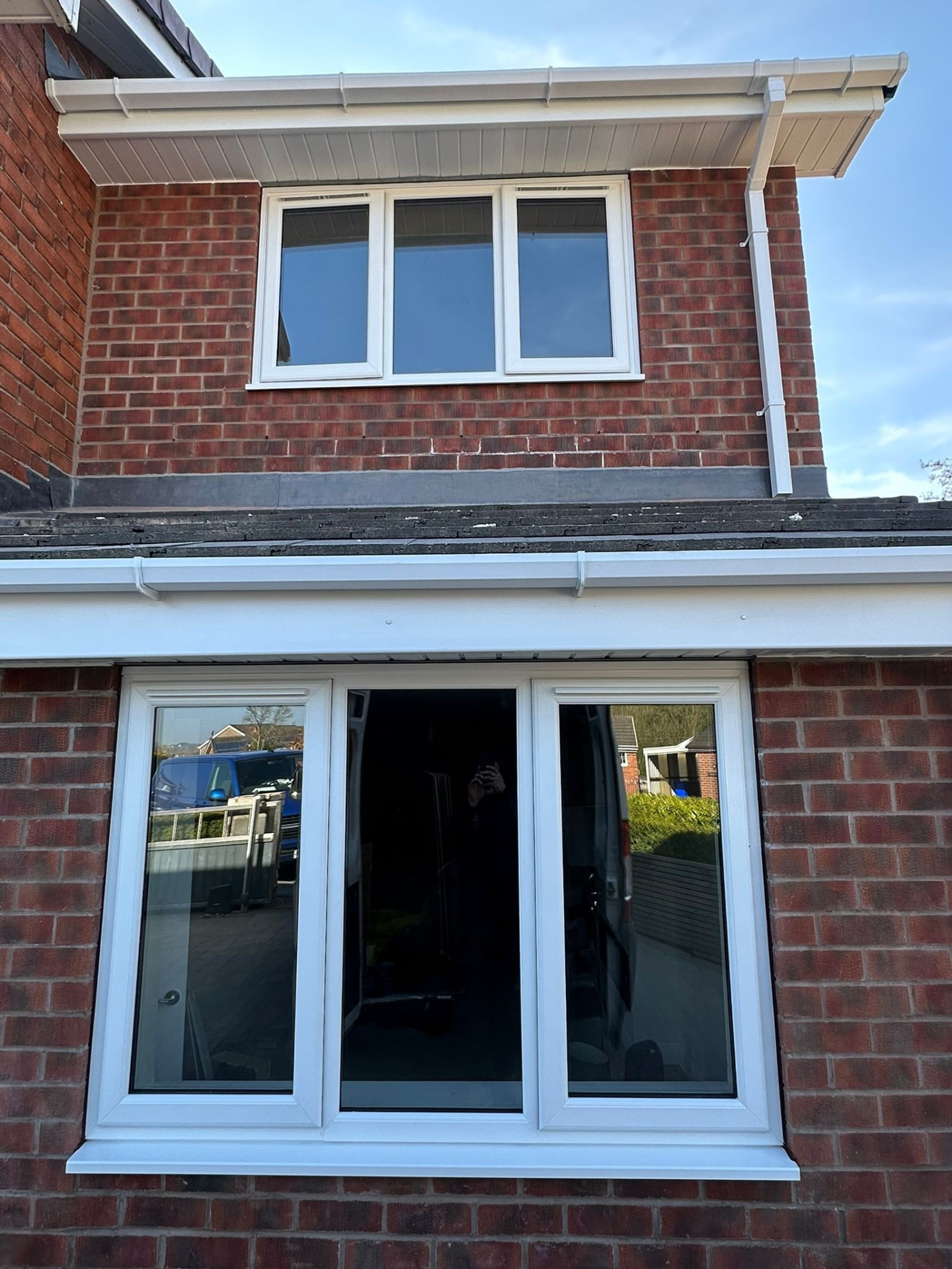 New white uPVC casement windows and roofline on a red brick house in Stoke-on-Trent