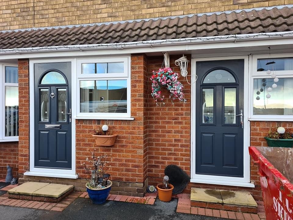 Pair of matching dark grey composite doors fitted to adjacent semi-detached homes