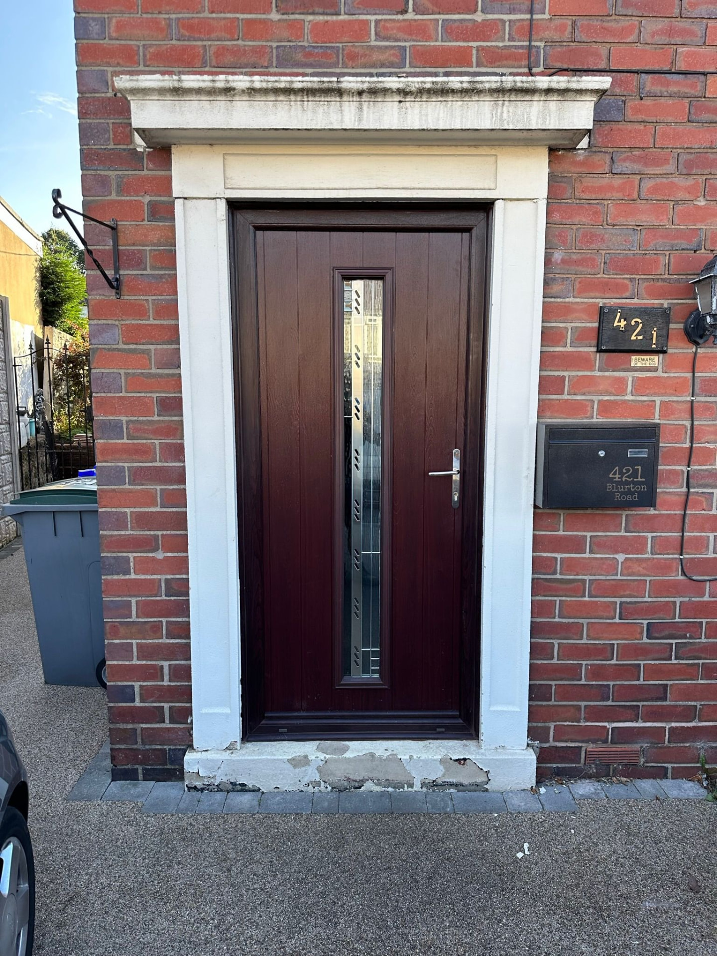 Mahogany wood-effect composite door with vertical frosted glass pane installed in Stoke-on-Trent