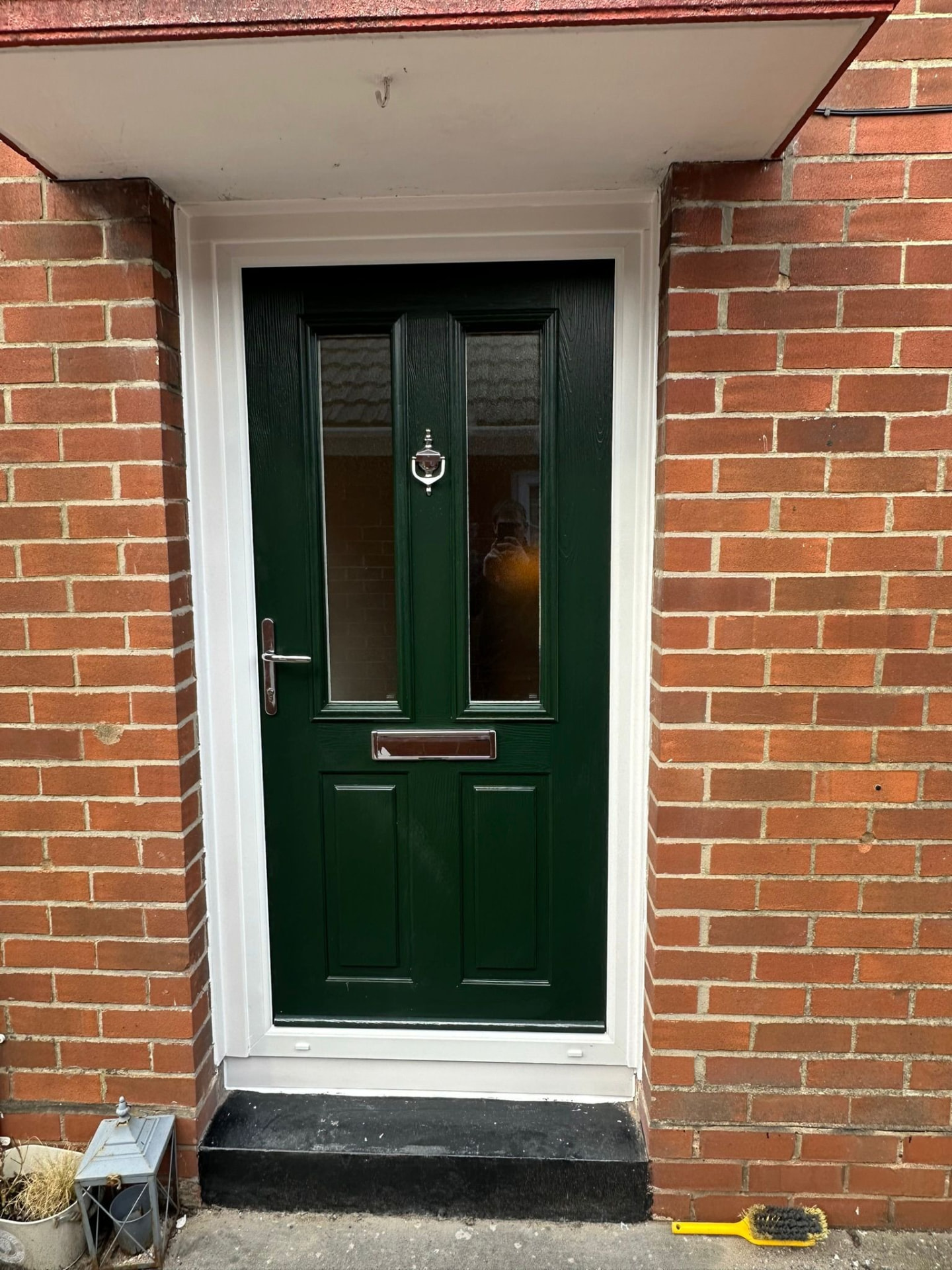 Dark green composite door with two vertical windows and silver knocker fitted in Cheshire