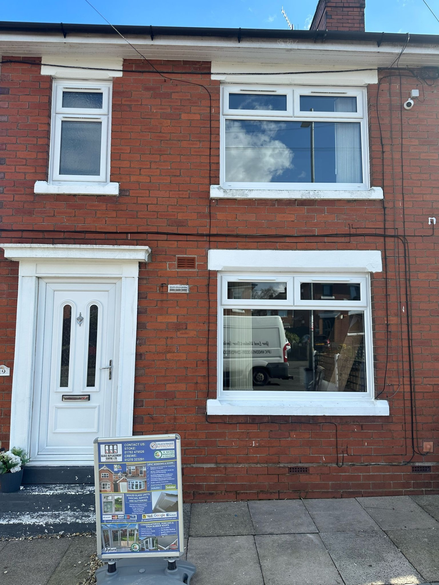 Terraced red brick house with new white uPVC windows and door in Stoke-on-Trent
